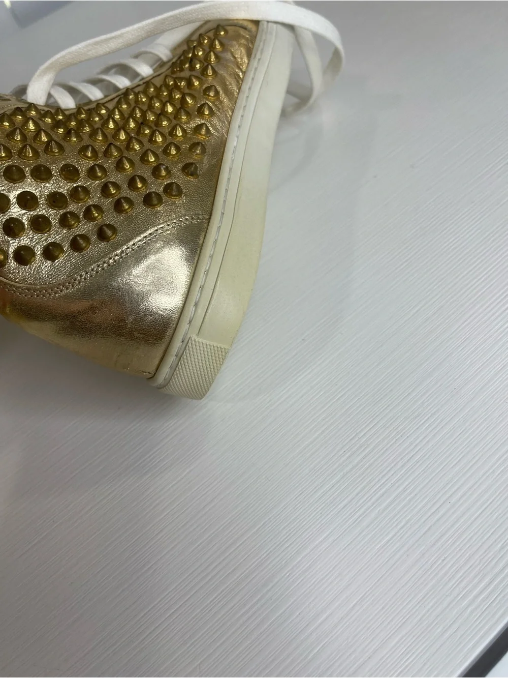 Metallic Gold High-Top Sneakers with Stud Details by Rodney P. Hunt